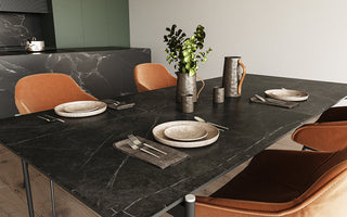 Modern dining table styled with a ceramic vase centerpiece