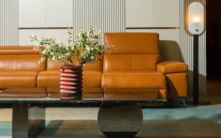 Modern full-grain leather sofa showcasing natural material patina over time.